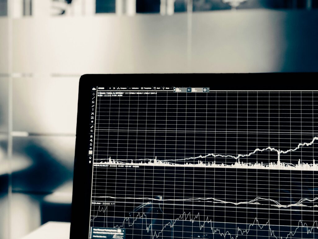 Financial trend chart climbing across a laptop screen in black and white
